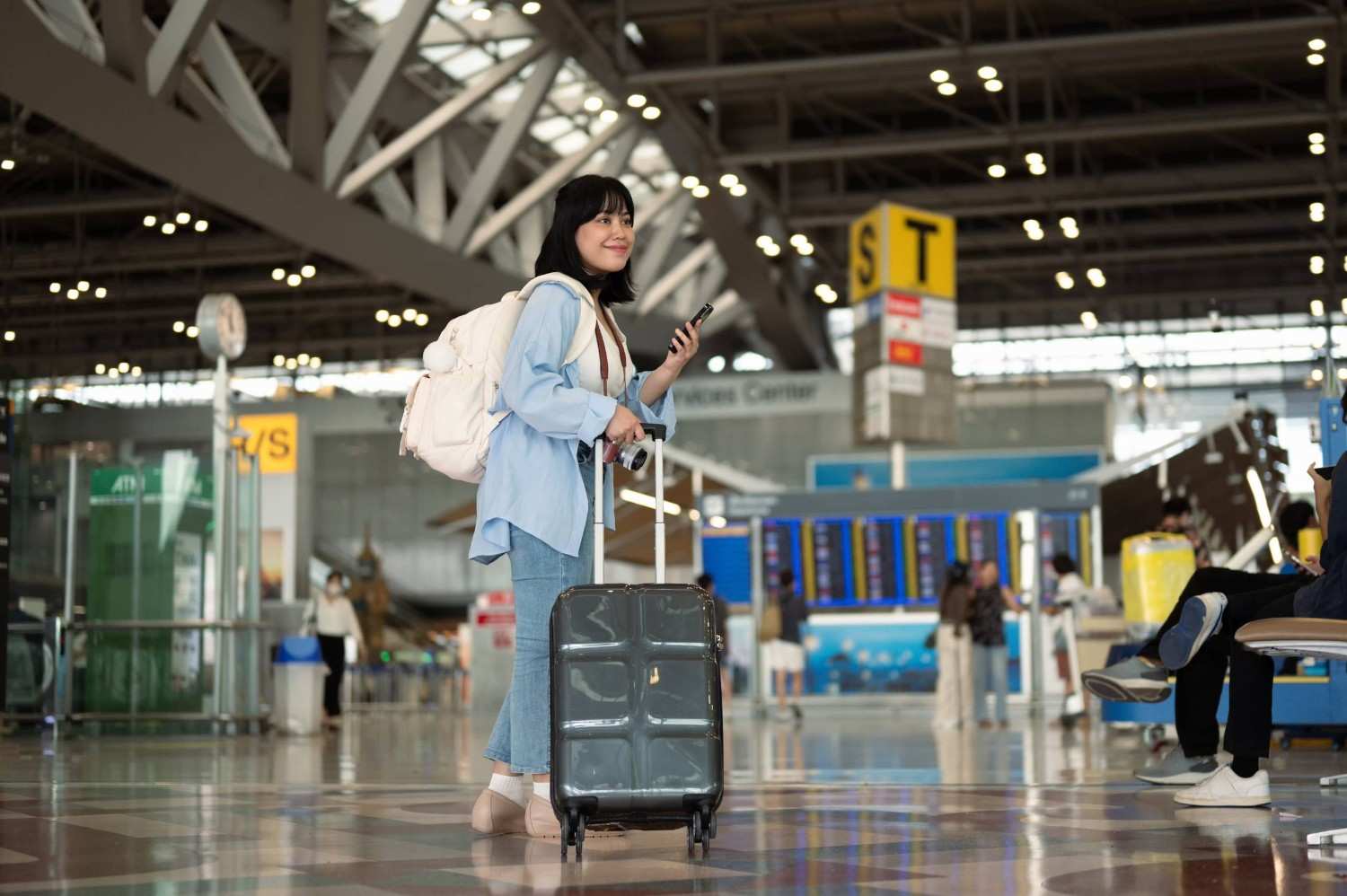 A Woman At The Airport With Luggage
