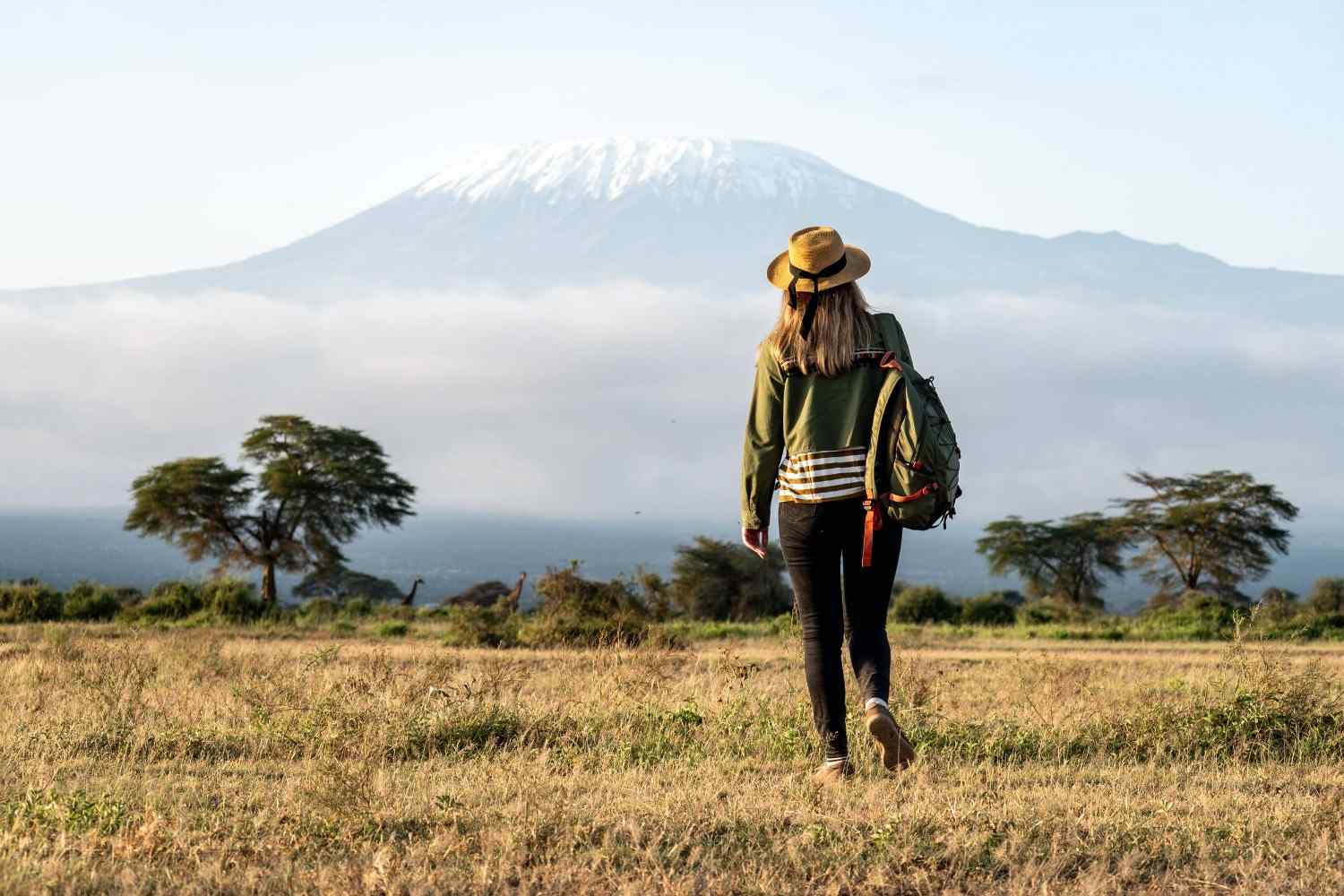 A Woman Standing Against A Backdrop Of Mount Kilimanjaro