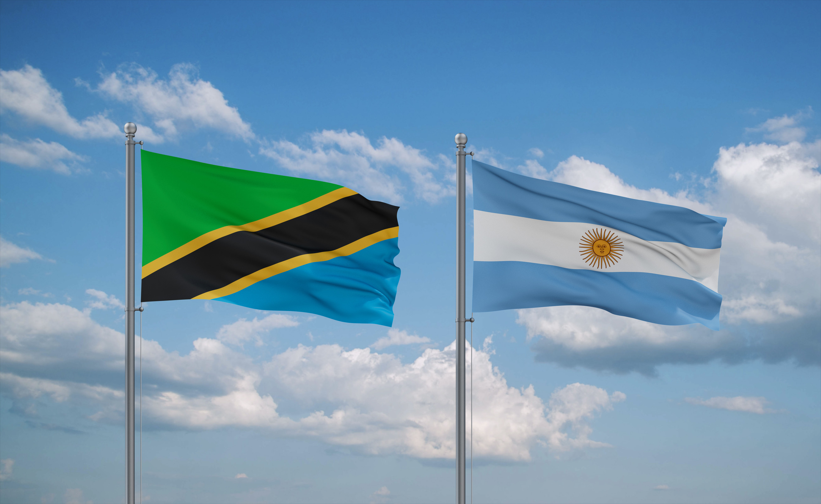 Argentina And Tanzania Flags Waving Together On Blue Cloudy Sky