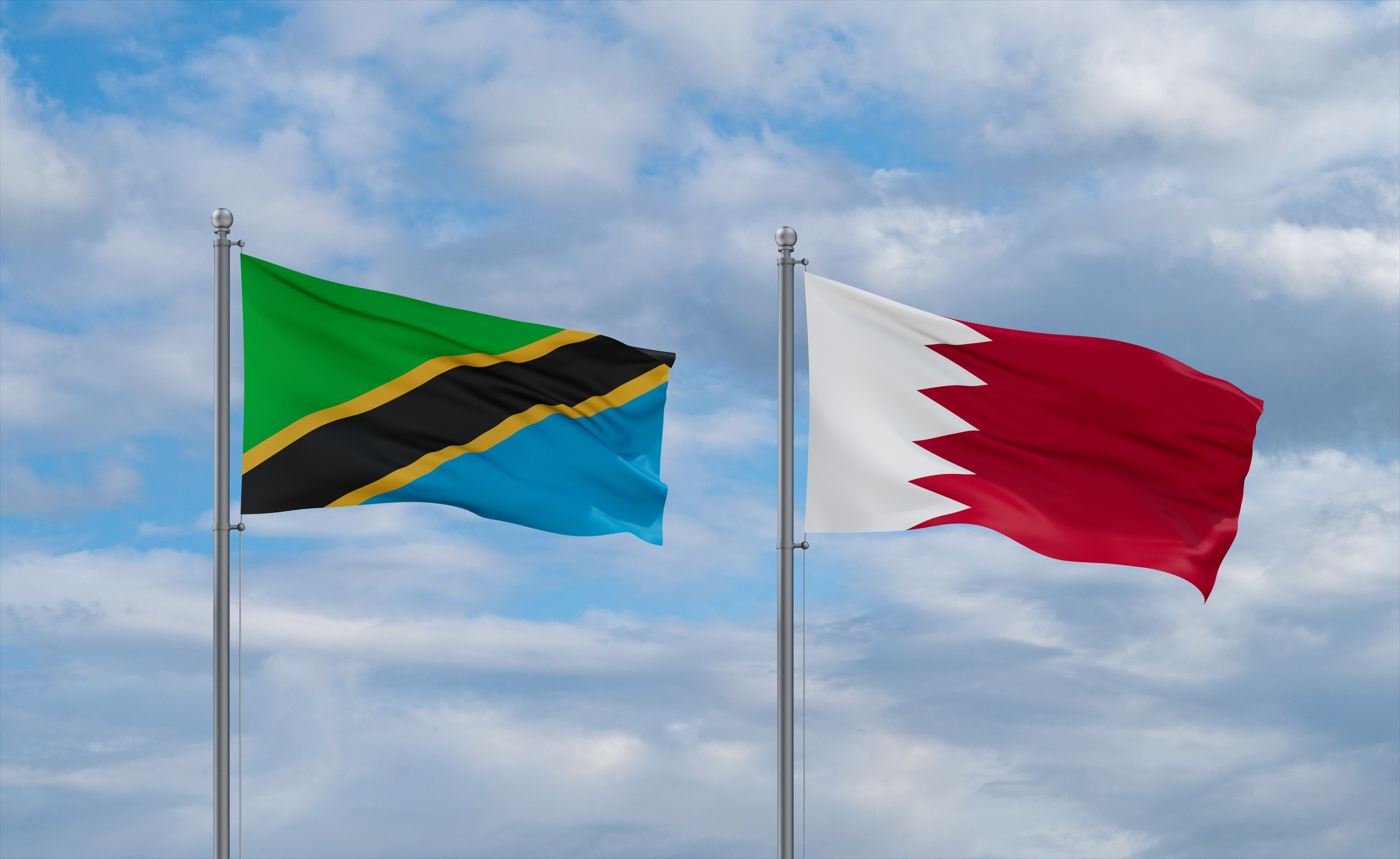 Bahrain And Tanzania Flags Waving Together On Blue Cloudy Sky Two Country