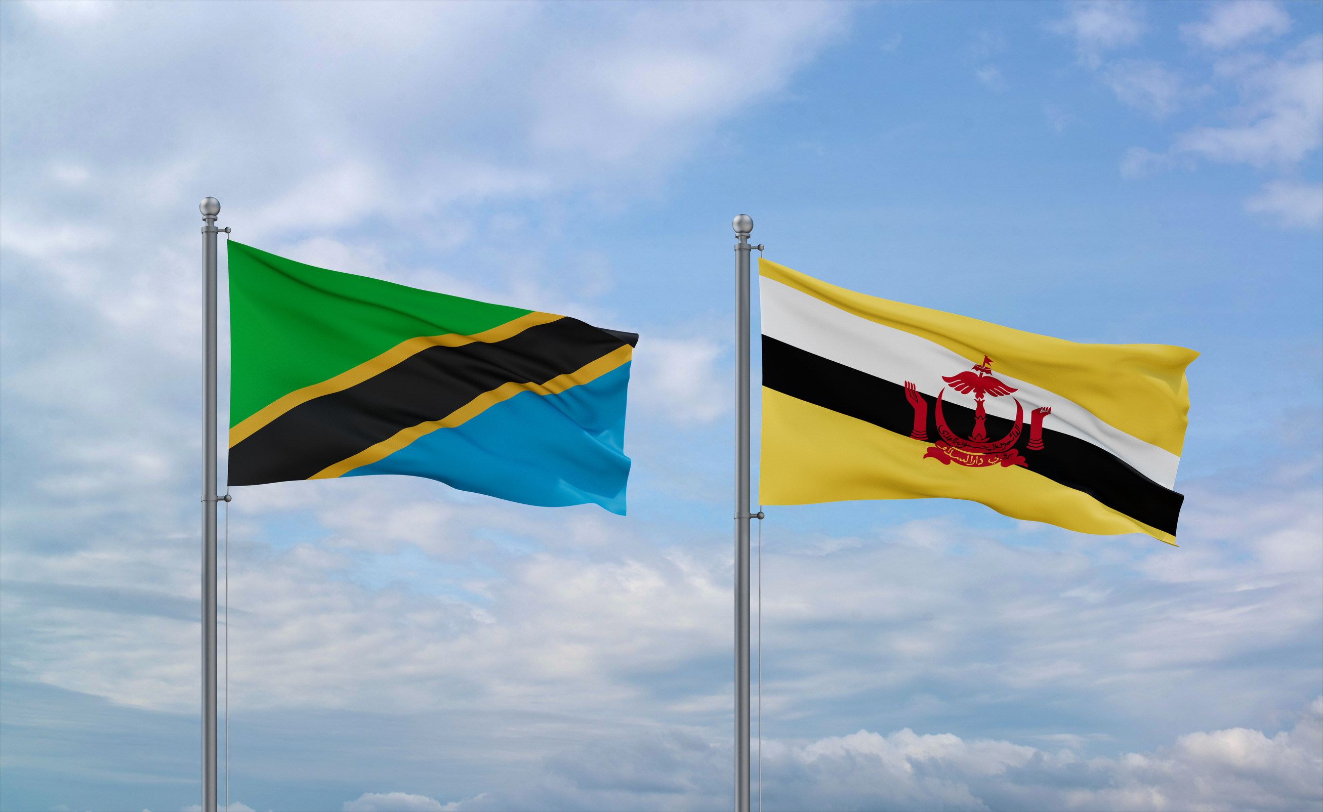 Brunei And Tanzania Flags Waving Together On Blue Cloudy Sky