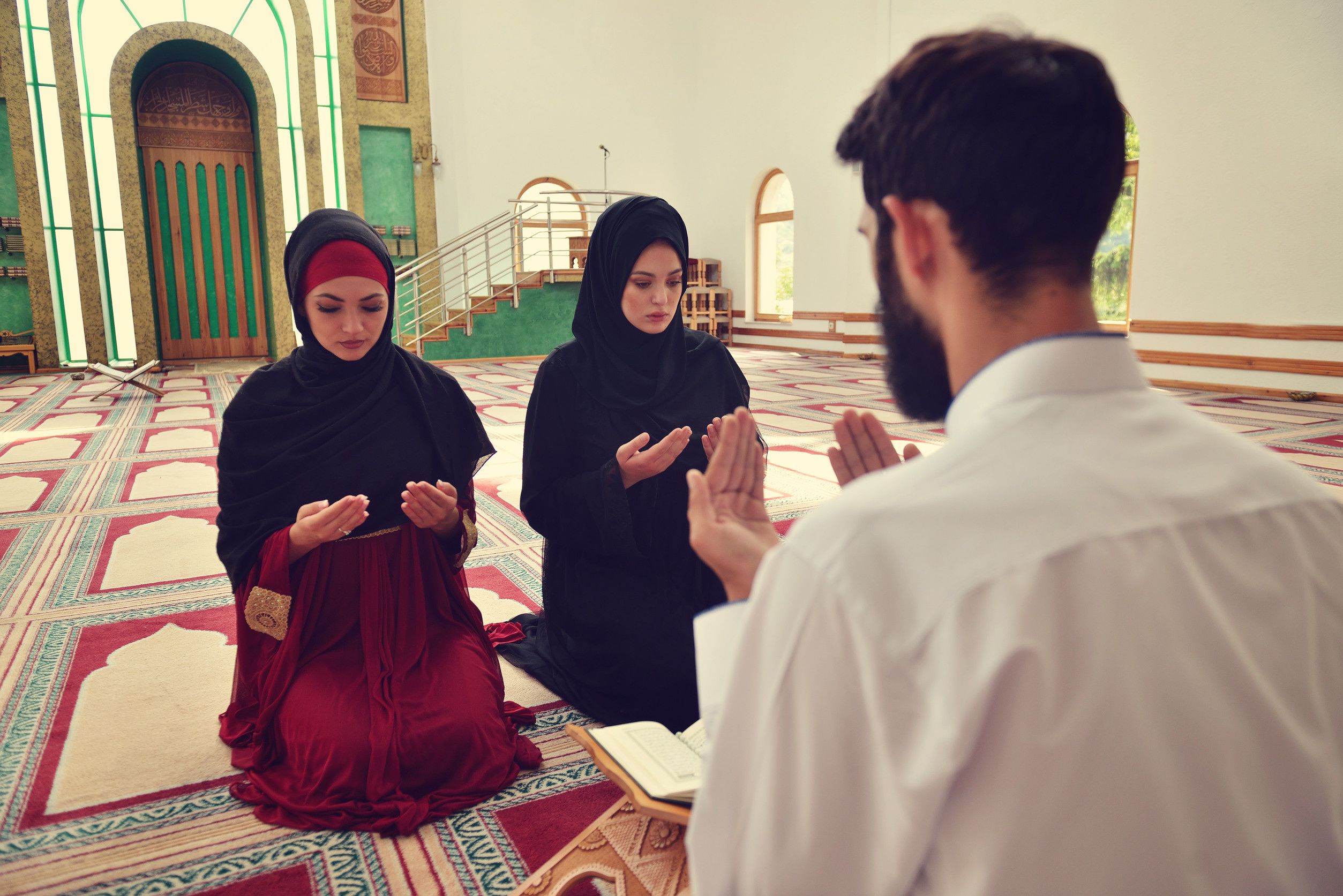 Muslim Man And Woman Praying In A Mosque