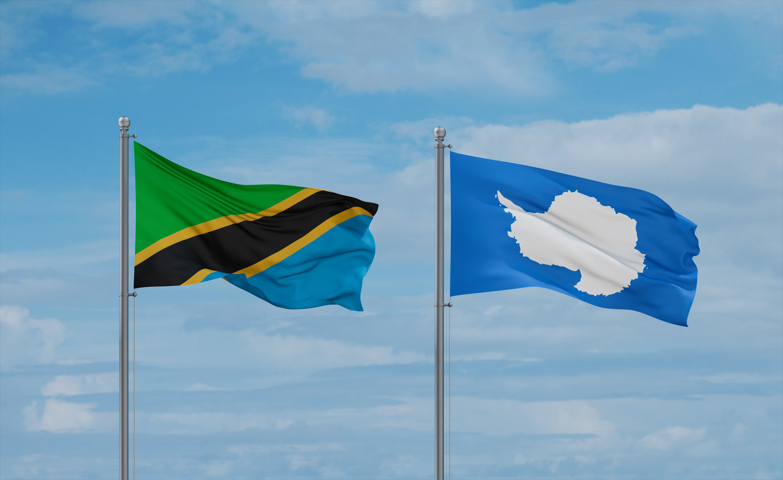 Tanzania And Antarctica Flags Waving Together In The Wind On Blue Cloudy Sky