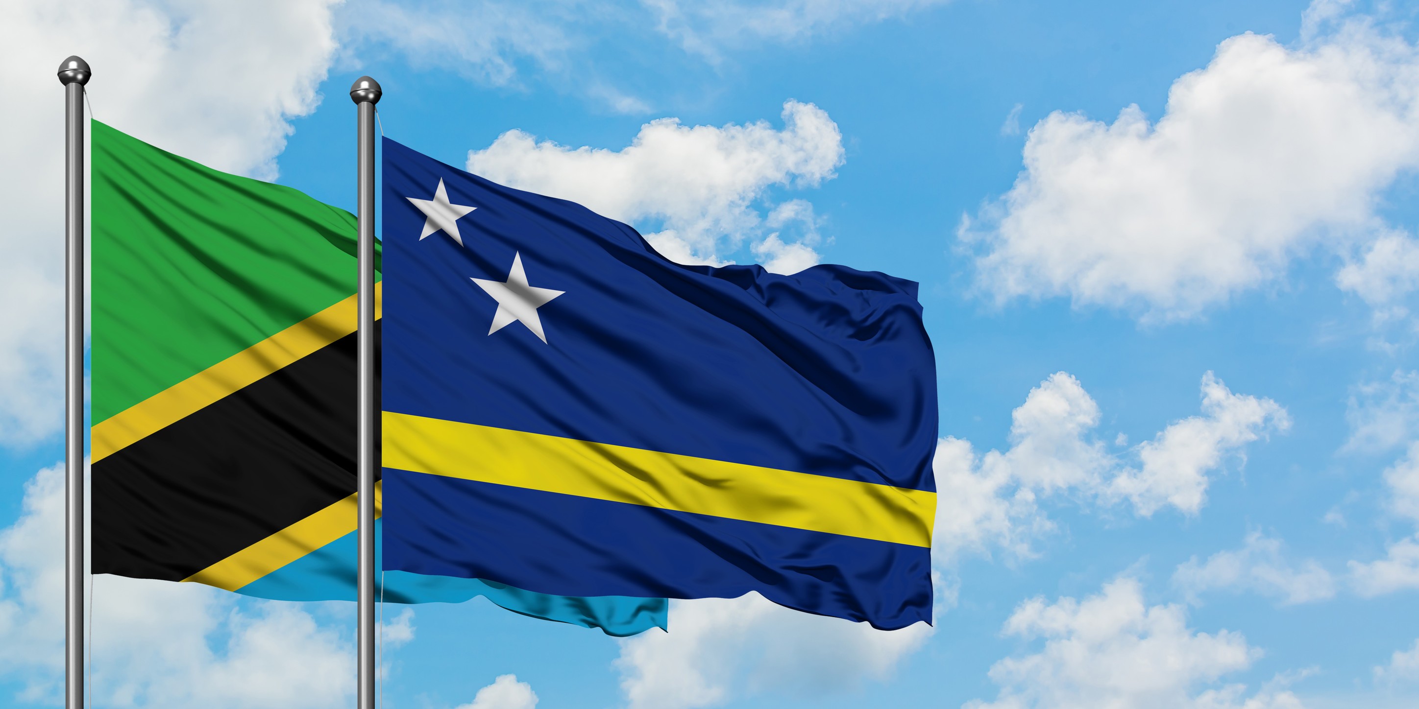 Tanzania And Curacao Flag Waving In The Wind