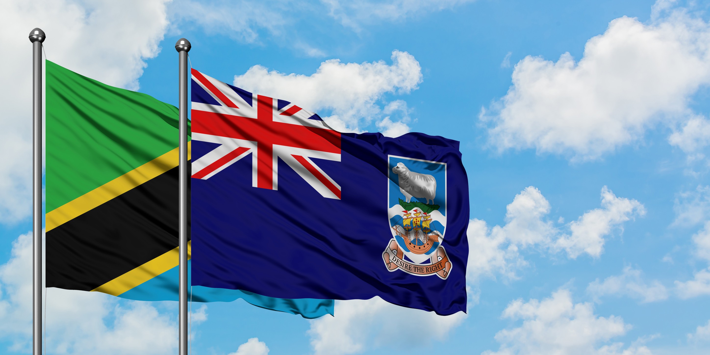Tanzania And Falkland Islands Flag Waving In The Wind Against