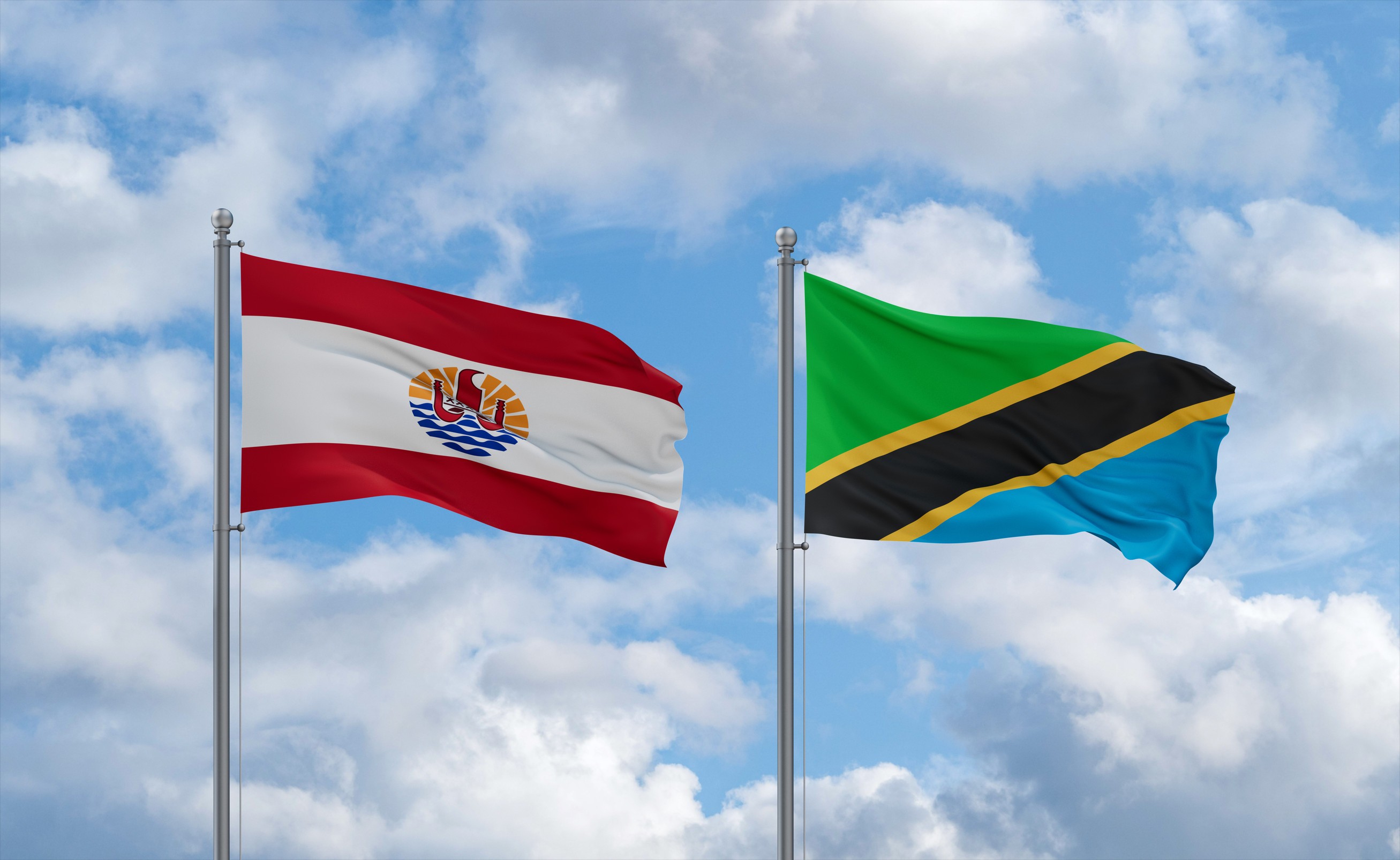 Tanzania And French Polynesia Flags Waving Together In The Wind On Blue Cloudy
