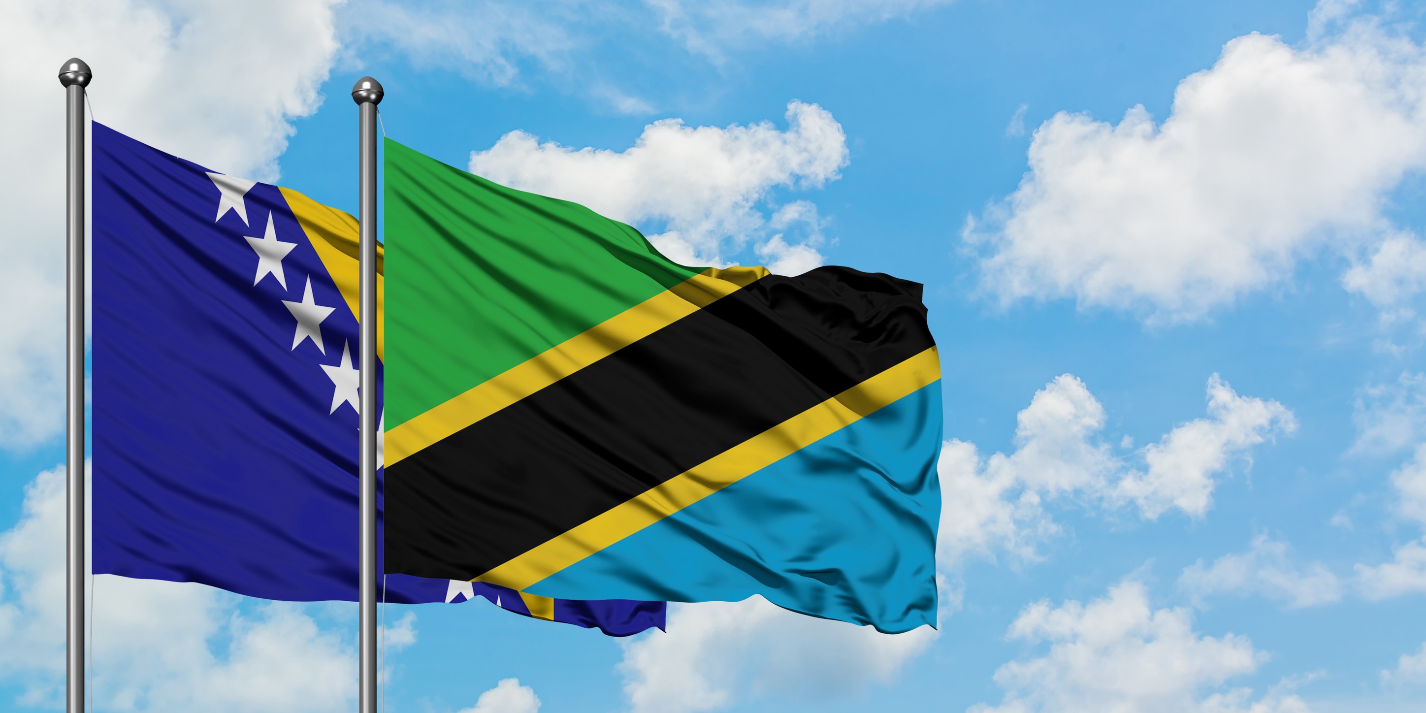 The Flags Of Bosnia Herzegovina And Tanzania Waving In The Wind