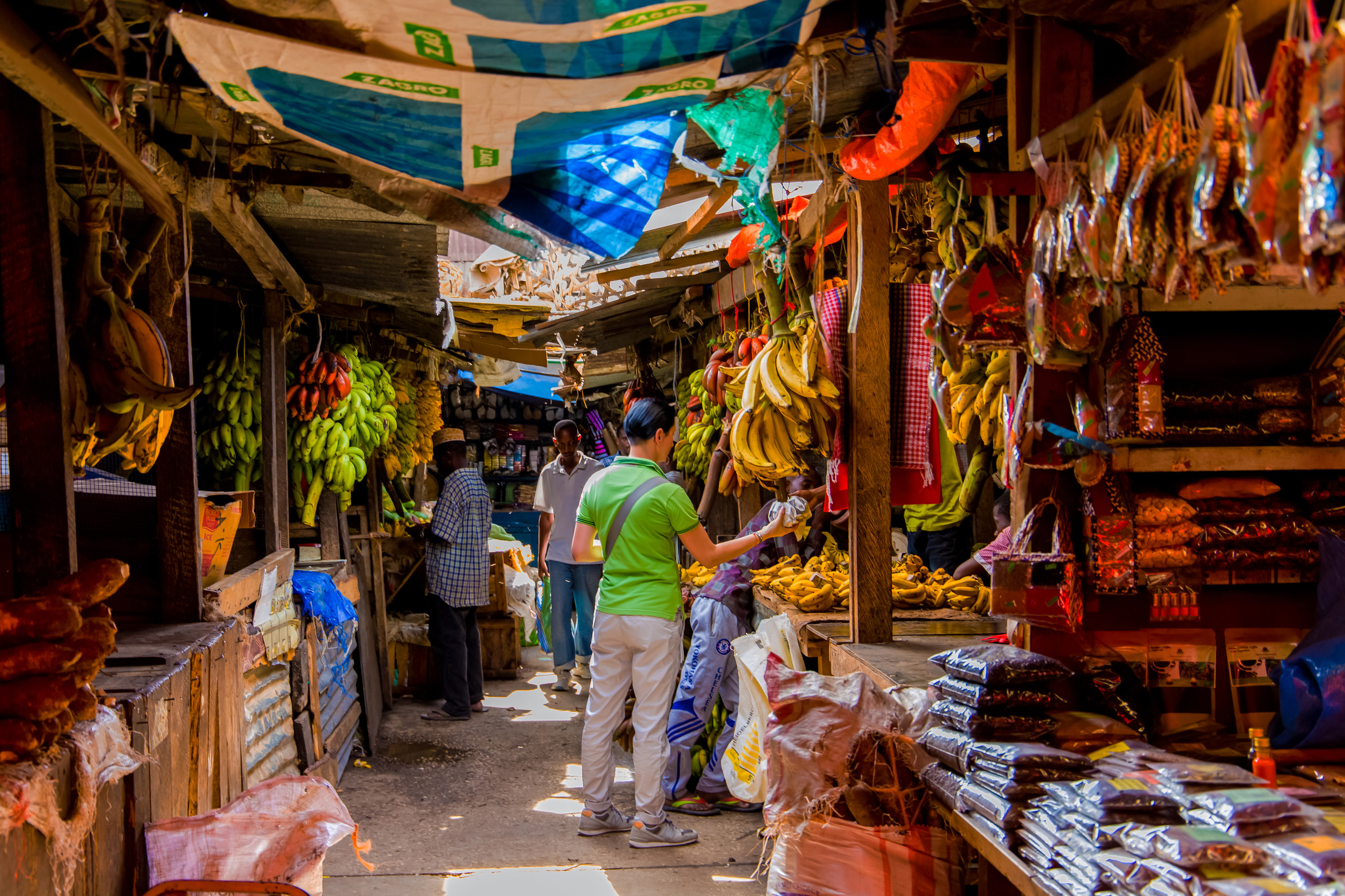 Tourists Exploring The Food Market In Stone Town In Zanzibar