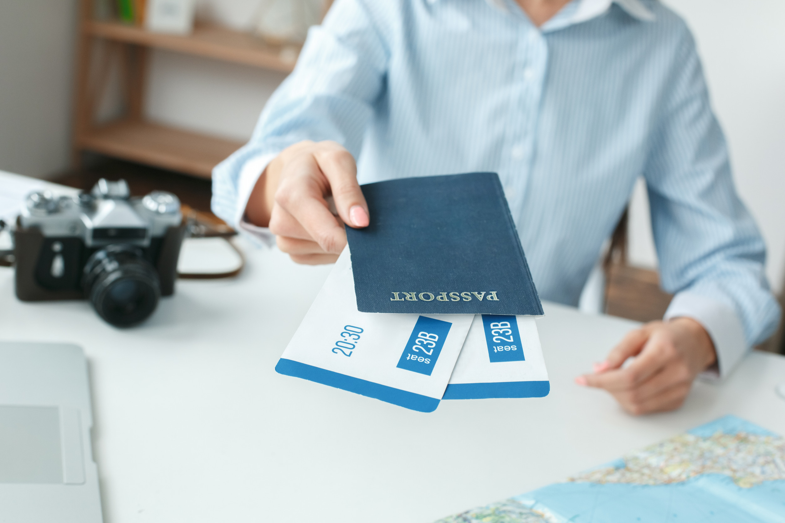 Young Female Travel Agent Consultant In Tour Agency Documents Close Up